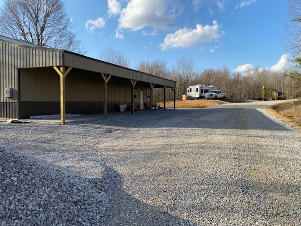 The park office with an RV at site in the distance