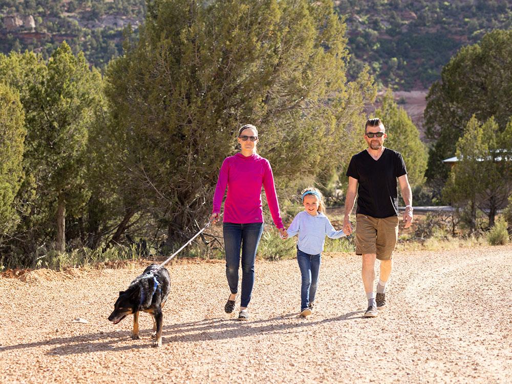 Holding hands walking a dog at BEST FRIENDS RV PARK