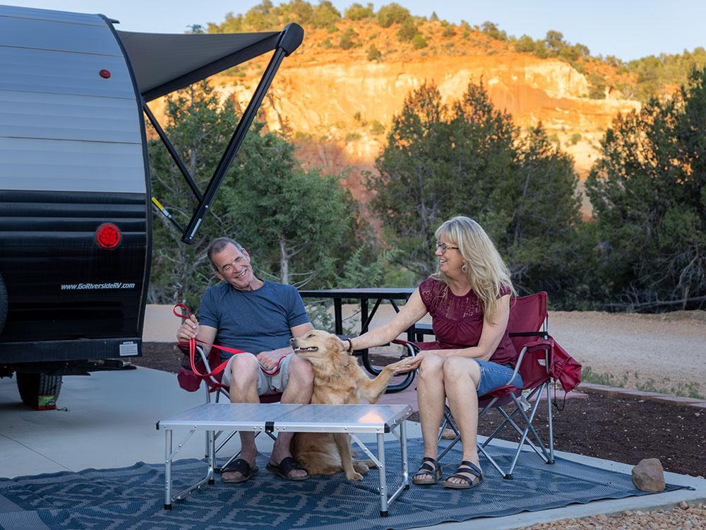 At a table with a dog at BEST FRIENDS RV PARK