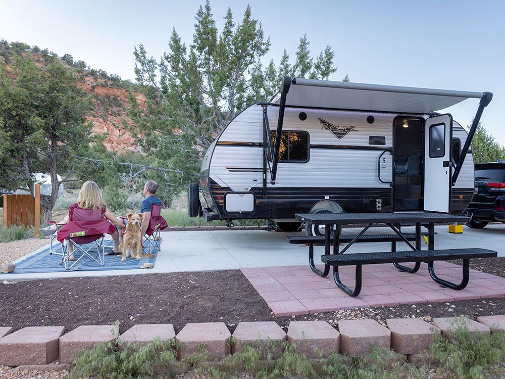 Sitting in chairs beside the RV at BEST FRIENDS RV PARK