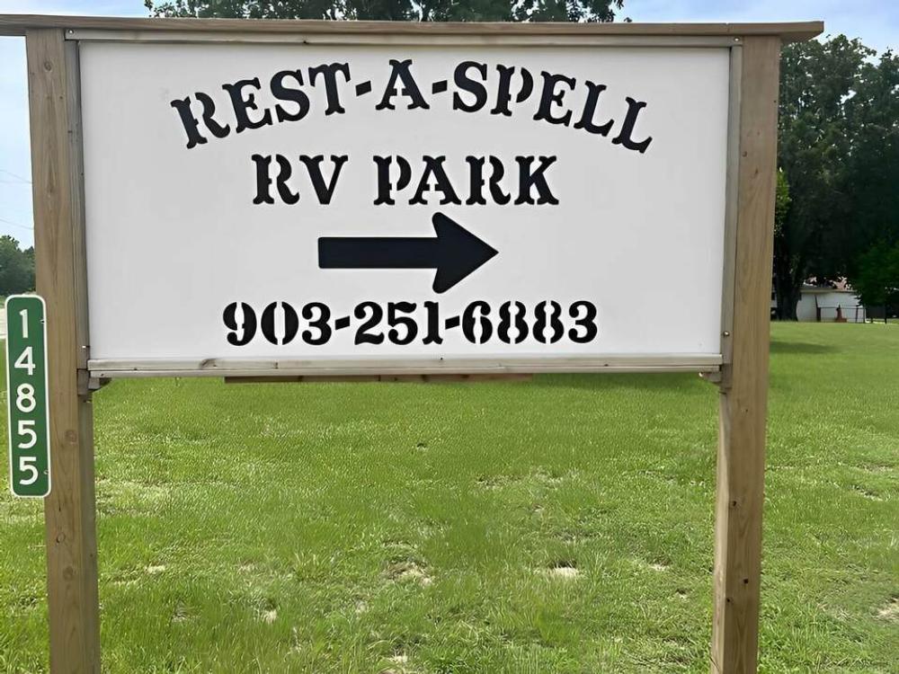 Entrance sign with phone number at Rest-A-Spell RV Park