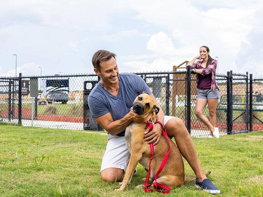 Man and dog in a dog park at Love's RV Stop - 602