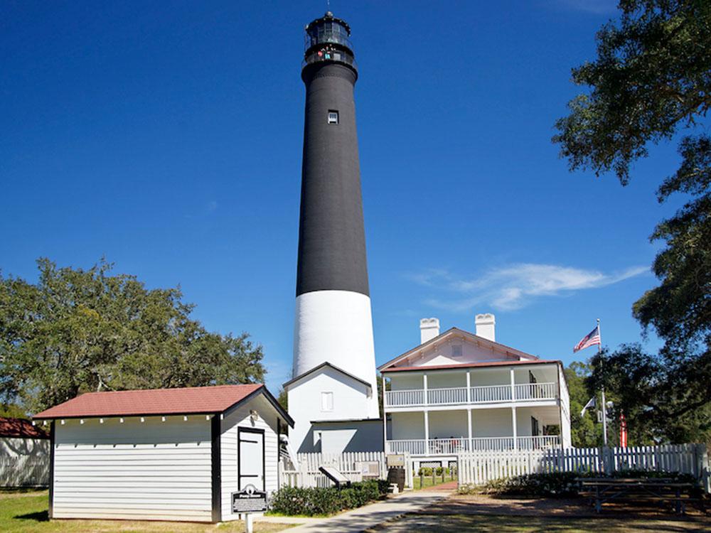 A lighthouse and house at PALM COVE RV VILLAGE