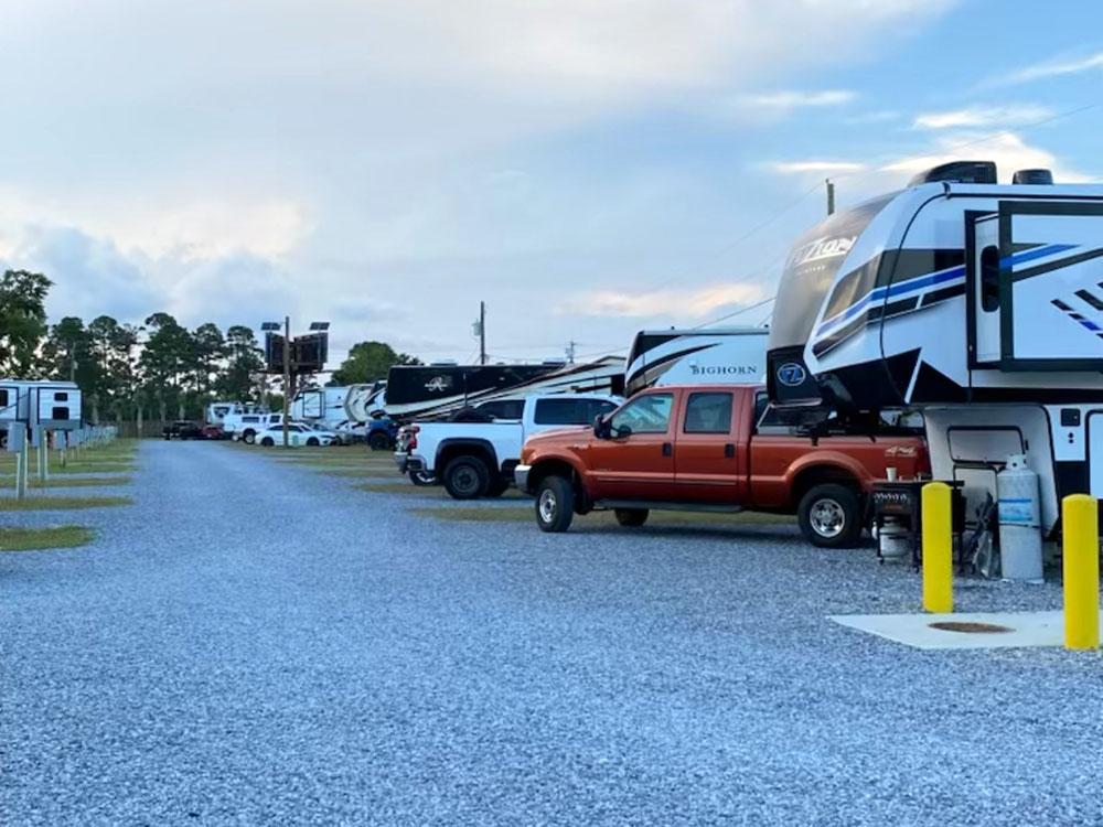 RVs in gravel sites at PALM COVE RV VILLAGE