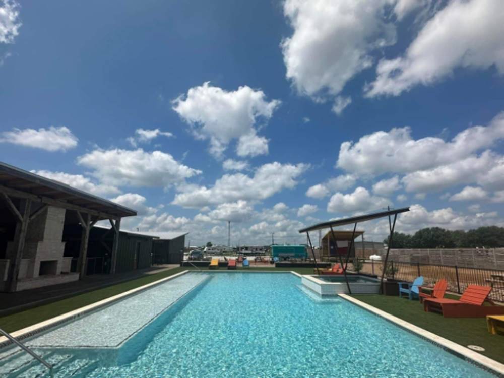 Empty pool area with chairs and fireplace