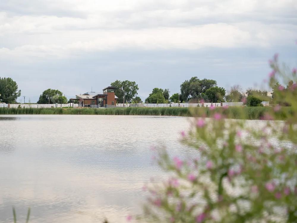 Pond with building in background at GOPHER GULCH RV & CAMPGROUND