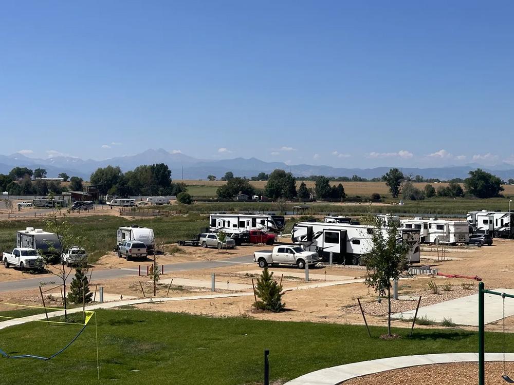 Parked RVs with mountains in background at GOPHER GULCH RV & CAMPGROUND