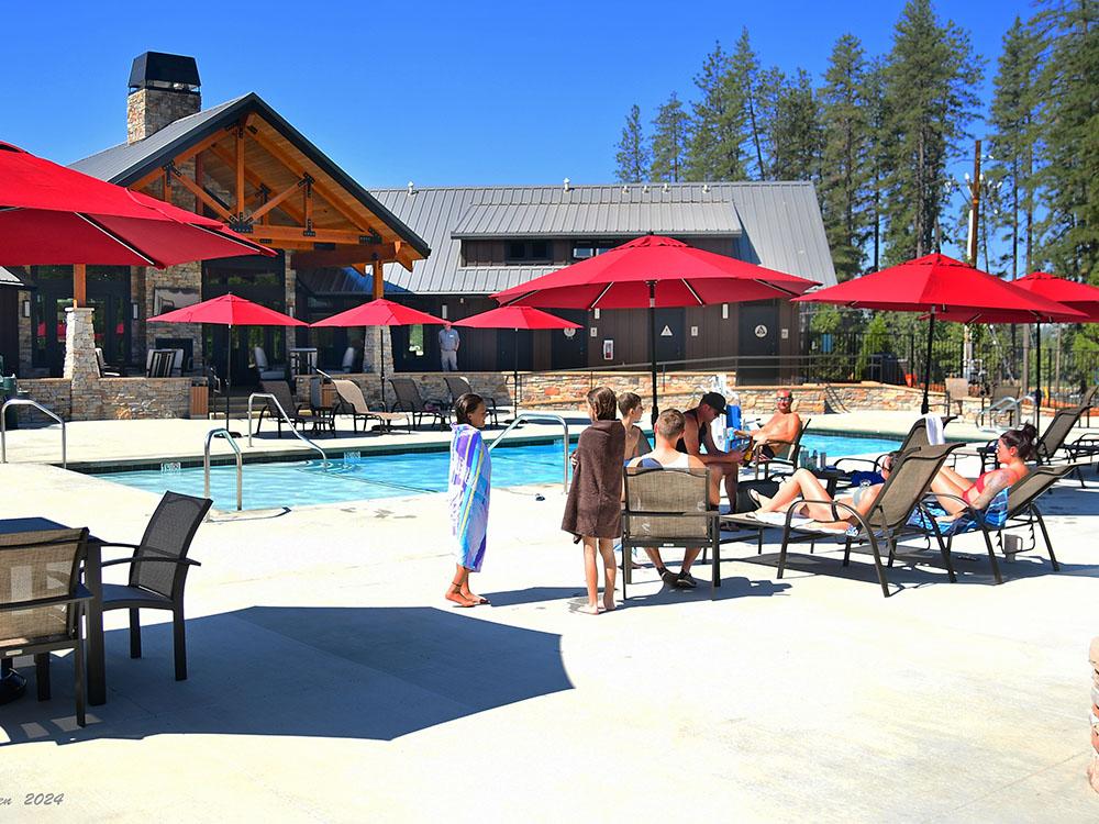 Red umbrellas around the pool at GRASS VALLEY RV RESORT