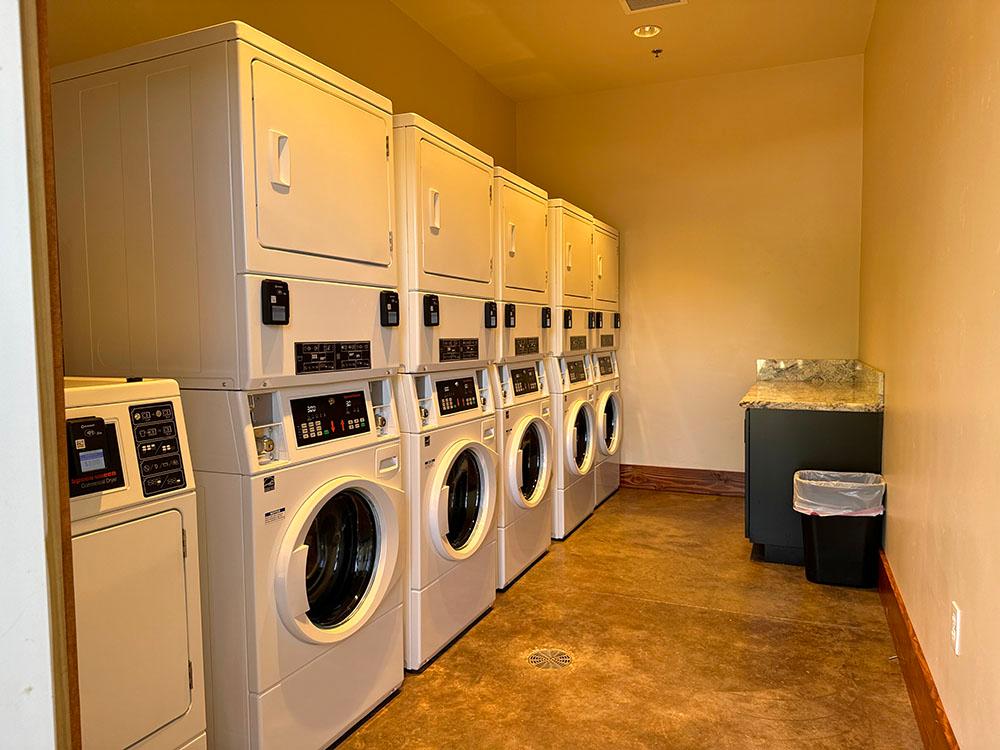 Laundry room with stackable washer and dryers at GRASS VALLEY RV RESORT