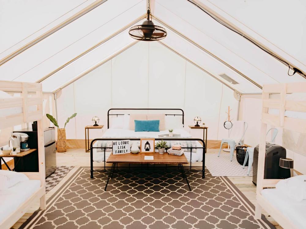 Bed inside glamping tent at Timberline Glamping at Lula