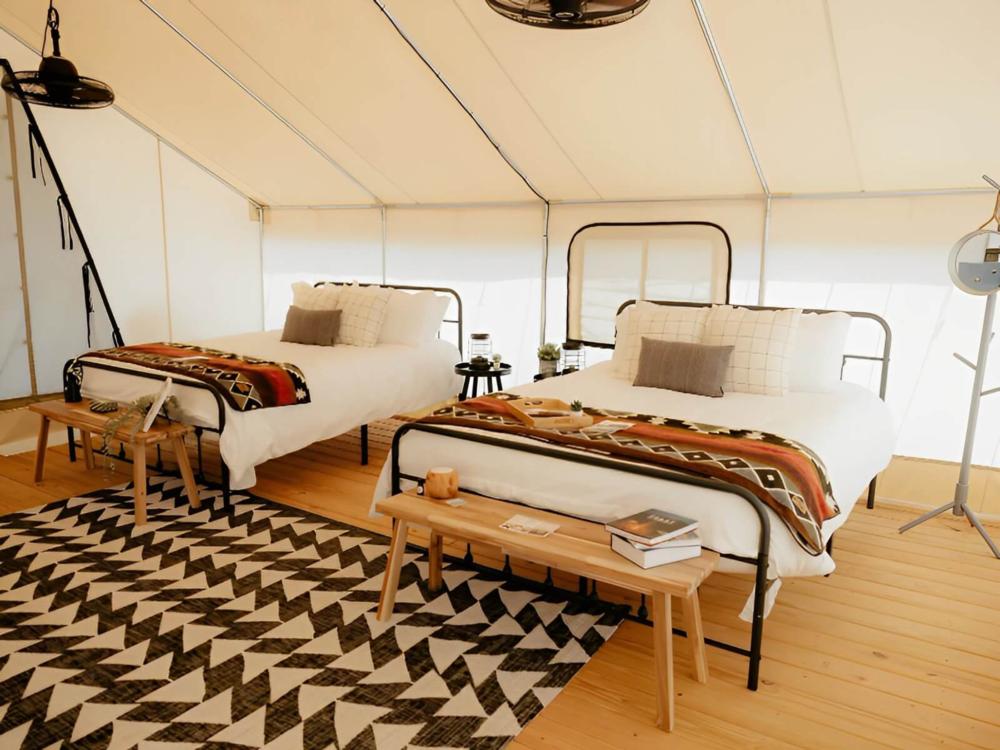 Beds inside tent at site Timberline Glamping at Lake Guntersville