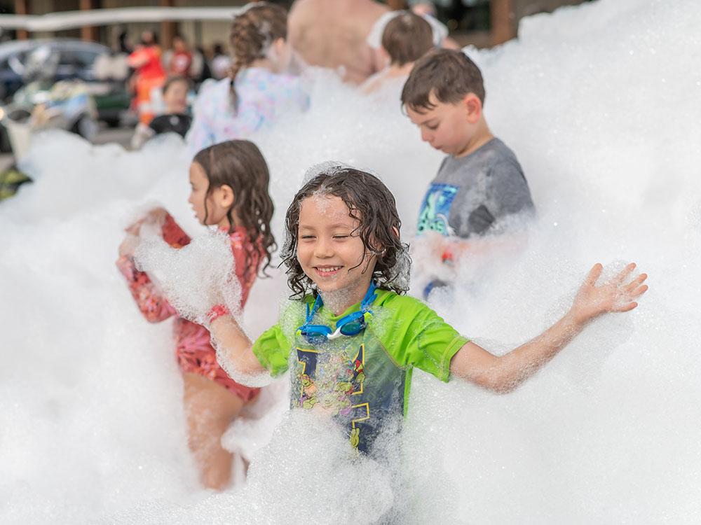 Kids playing in bubbles at CAMP FIMFO WACO