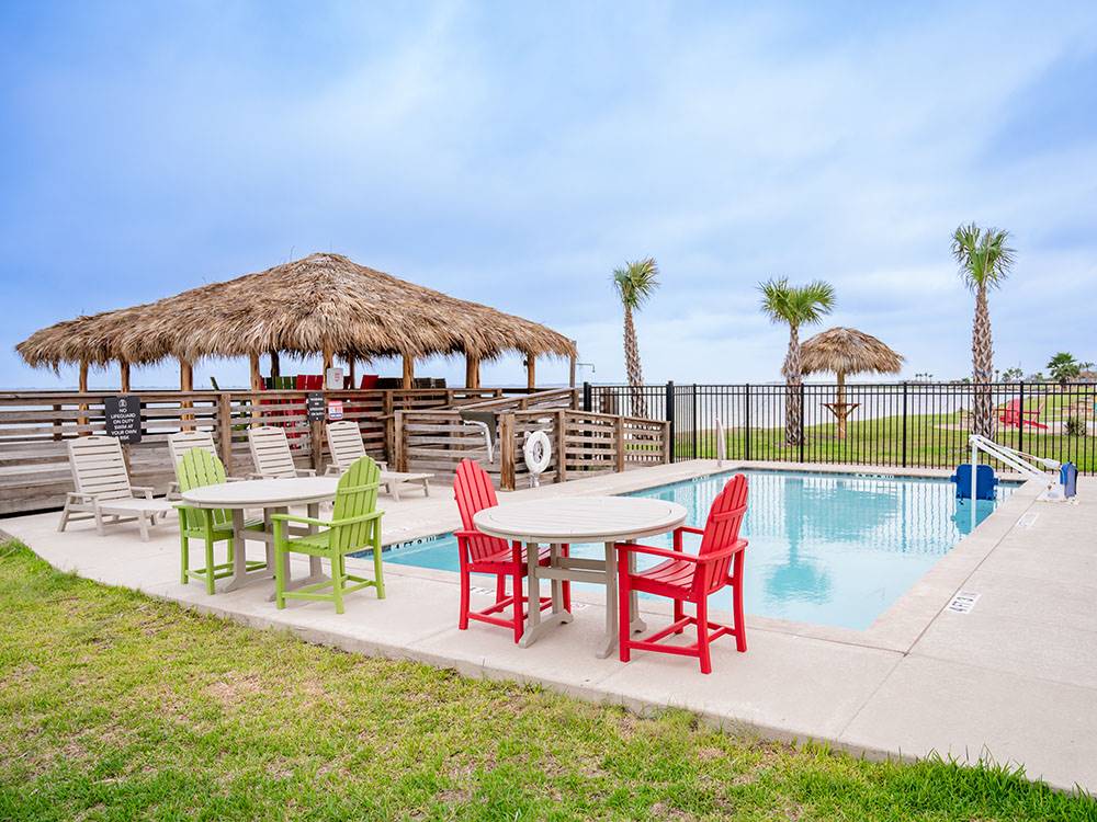 Pool area with tables and chairs at Firefly Resort Coastal Bend