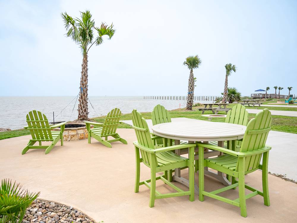 Tables and chairs with an ocean view at Firefly Resort Coastal Bend