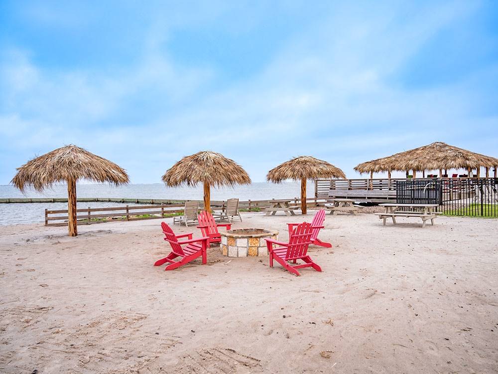 Umbrellas and chairs in the sand at Firefly Resort Coastal Bend