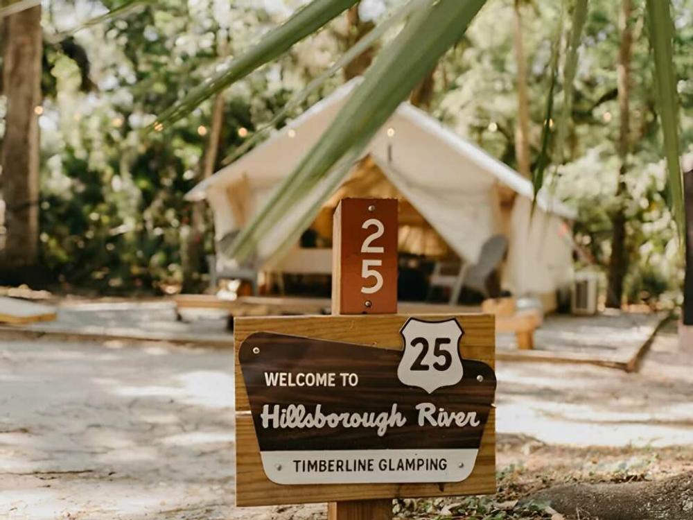 Welcome sign and glamping tent at Timberline Glamping at Hillsborough River