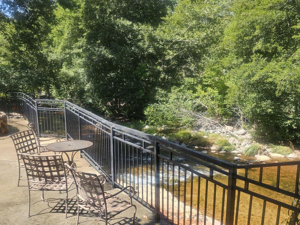 Seating overlooking the creek at OAK CREEK MOBILODGE