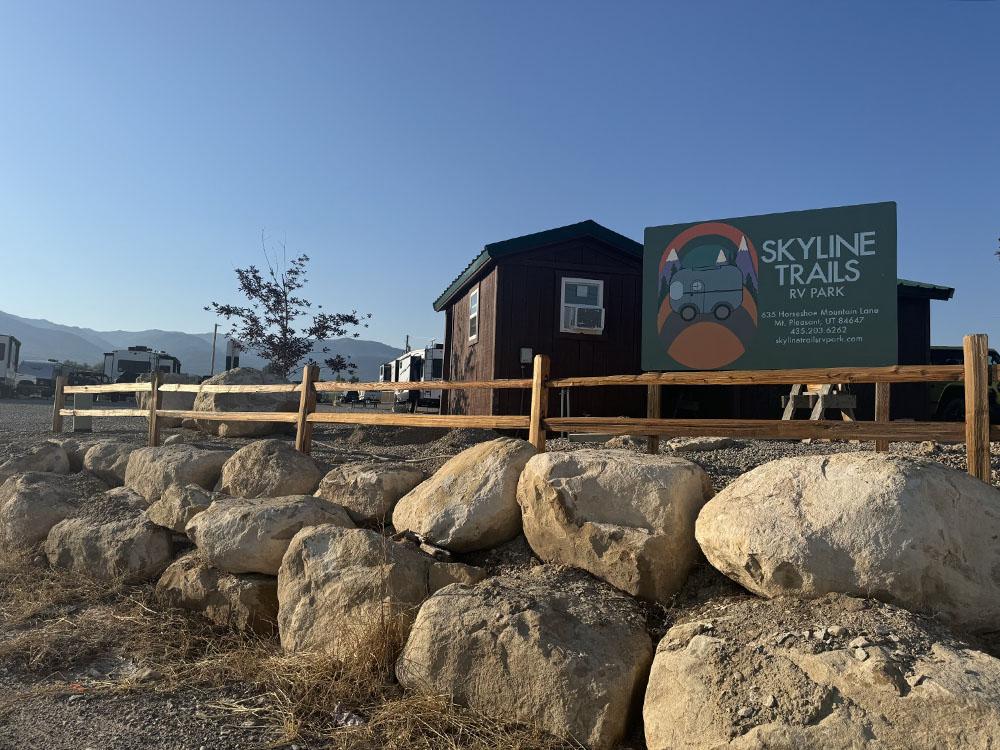 Park sign in front of a building at SKYLINE TRAILS RV PARK