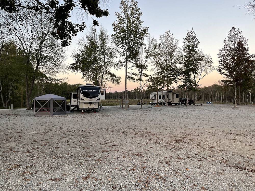 RV with a tent outside at Natchez RV Park