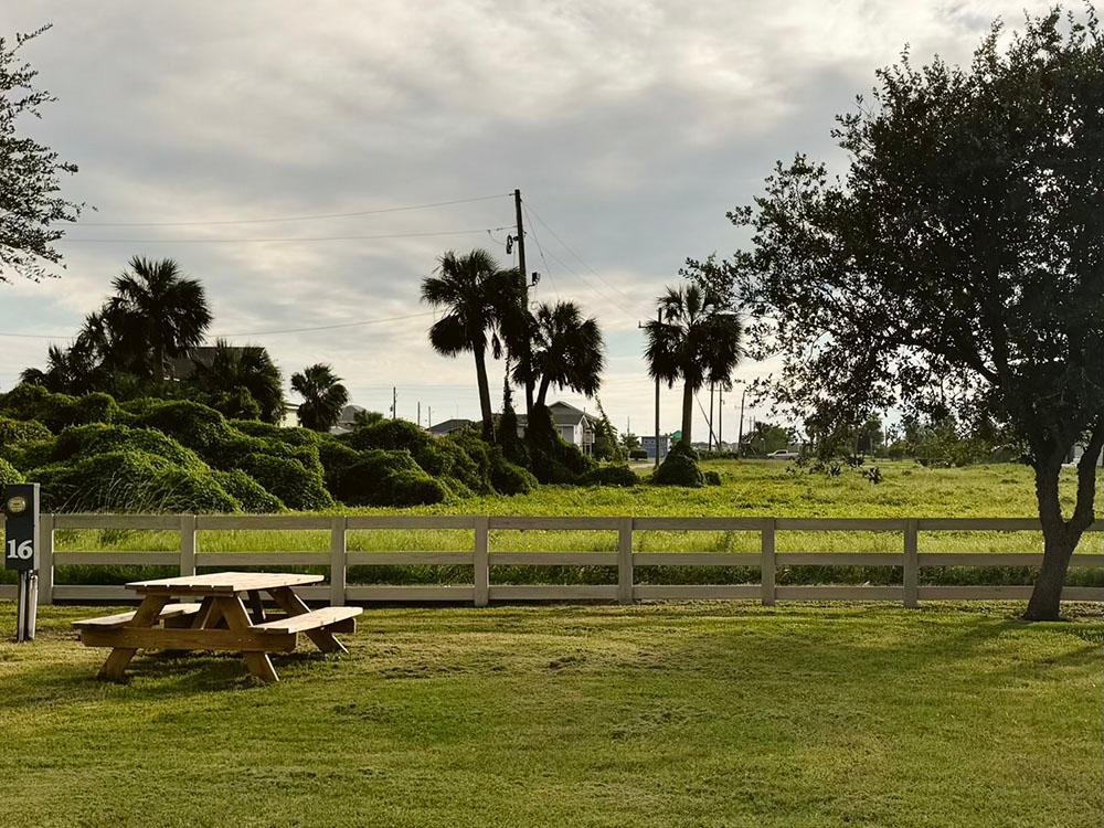 A picnic table in a grassy area at SANDOLLAR RV PARK