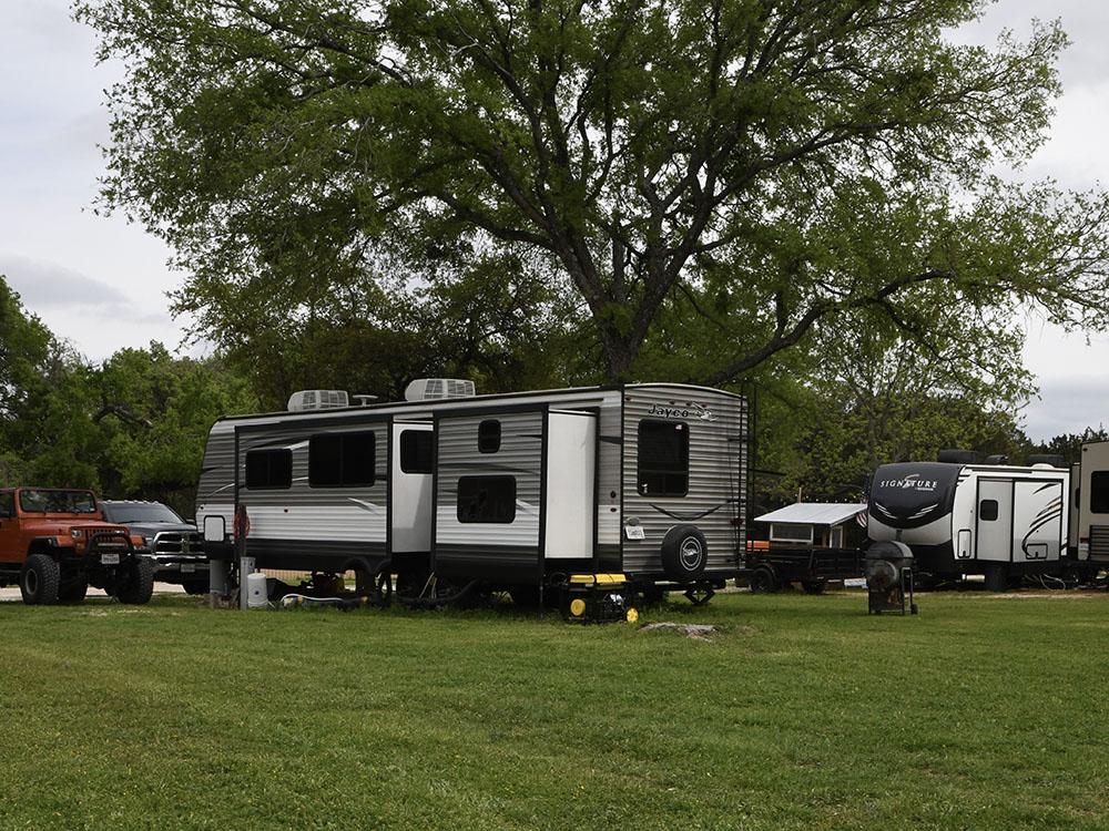 RVs parked in grassy sites at OUR FRIENDS CAMPGROUND