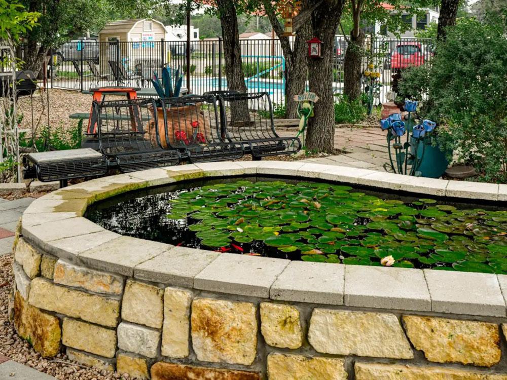 An amber stone koi pond at OUR FRIENDS CAMPGROUND