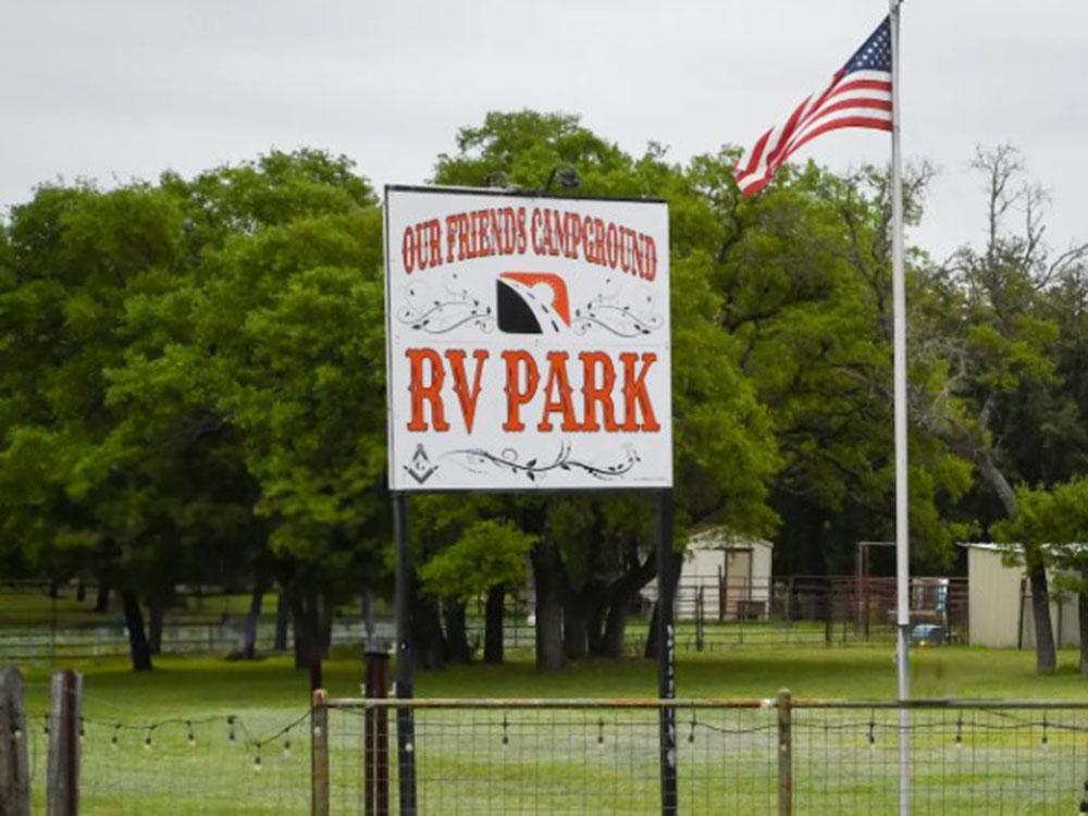 The park sign and an American flag at OUR FRIENDS CAMPGROUND