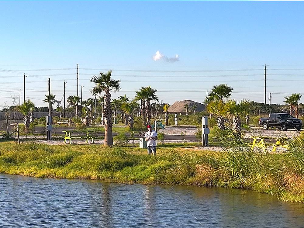 A man fishing in the pond at Galveston Island RV Park