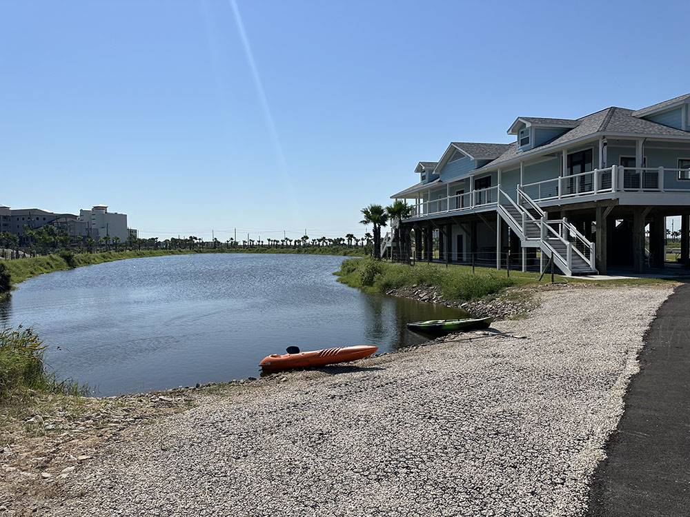 Kayaks at the shore of the pond at Galveston Island RV Park