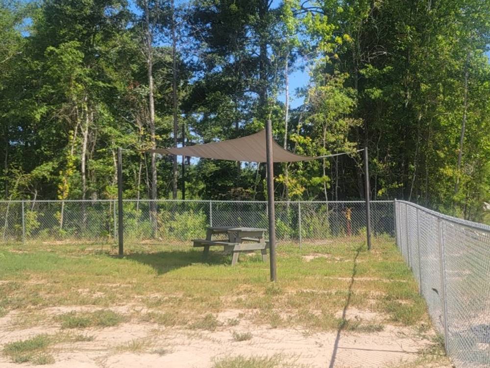 A shaded picnic table in the pet area at The Escapes RV Park & Storage