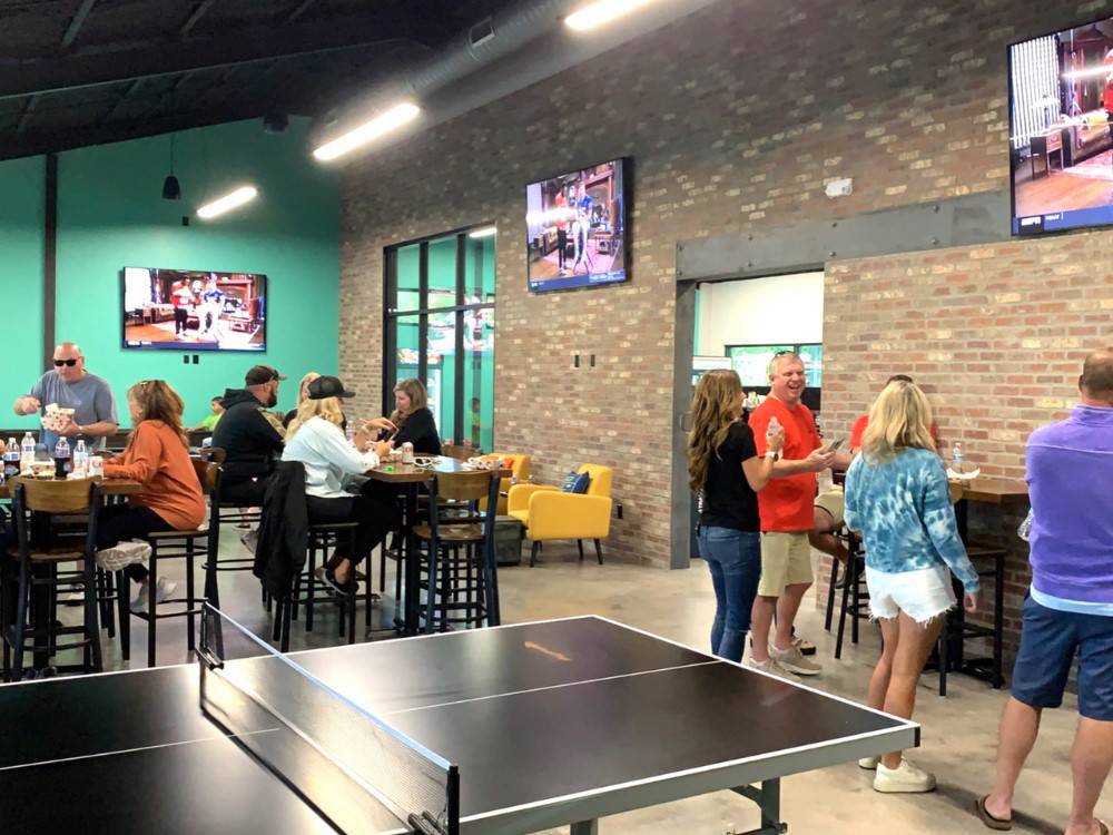 People dining and socializing in the rec hall at LHTX RV Resort