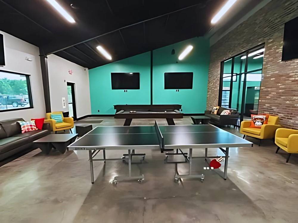 Ping pong and seating in the rec hall at LHTX RV Resort