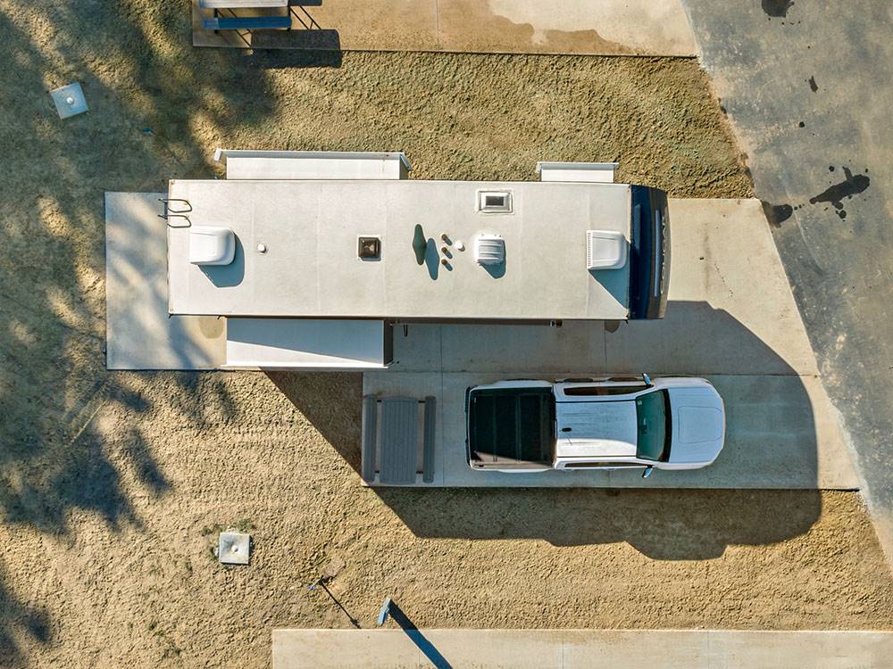 Aerial view of truck and fifth wheel parked at site at Blue Springs RV Park