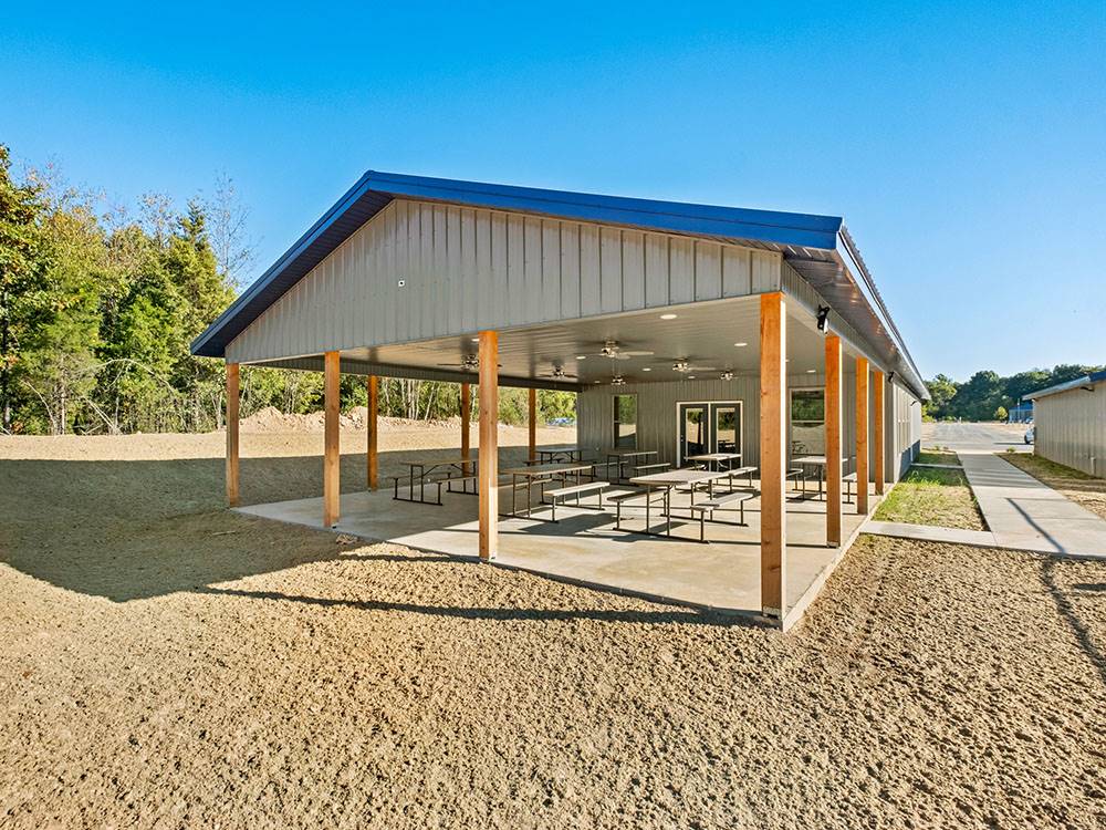 Covered outdoor seating with picnic tables at Blue Springs RV Park