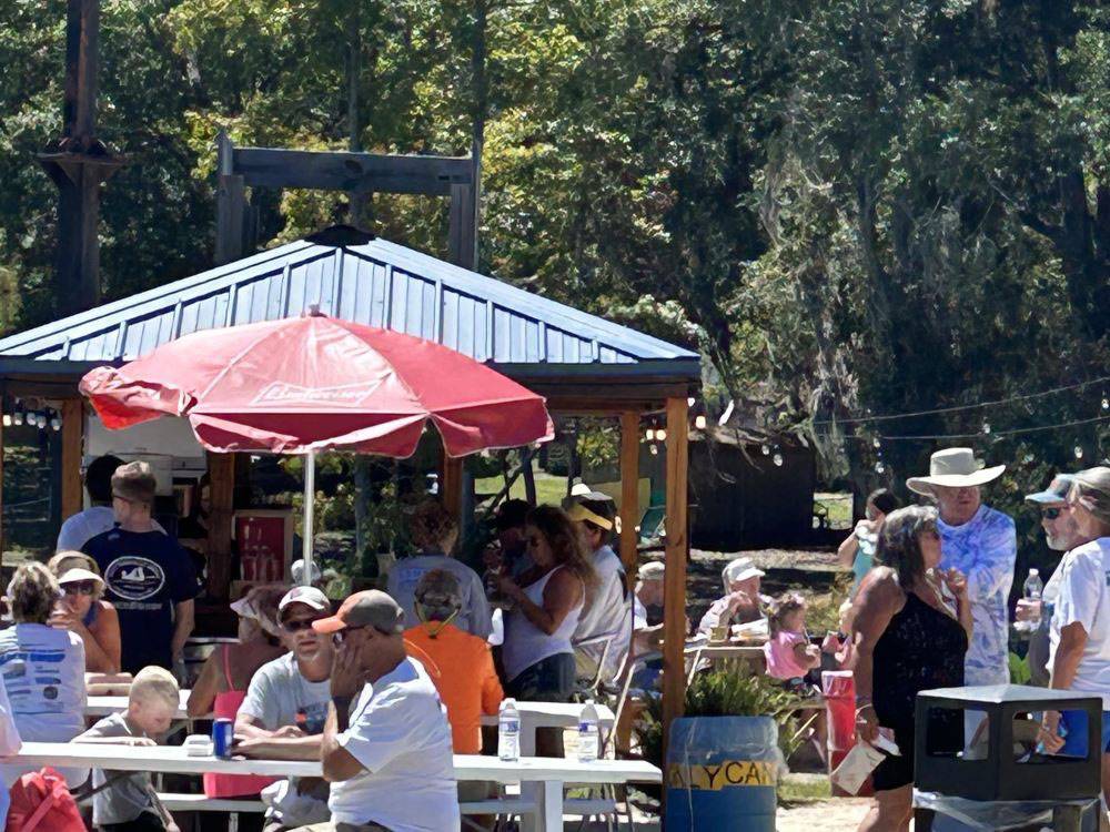 Multi generational people gathering at tables at Mill Creek Marina & Campground