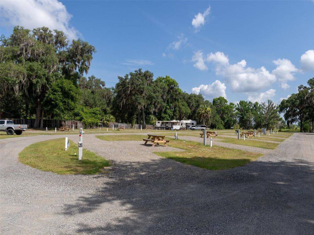 Gravel RV sites with hookups and picnic tables at Old Florida RV Resort