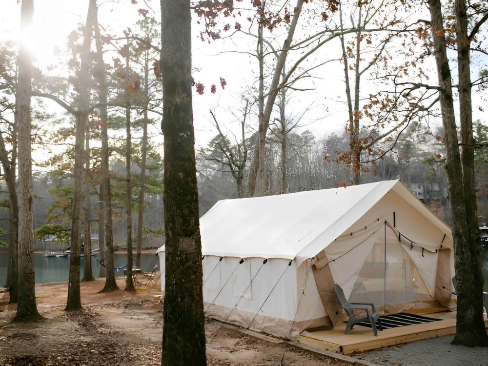 Side view of tent with lake in the back at Timberline Glamping at Williamsburg