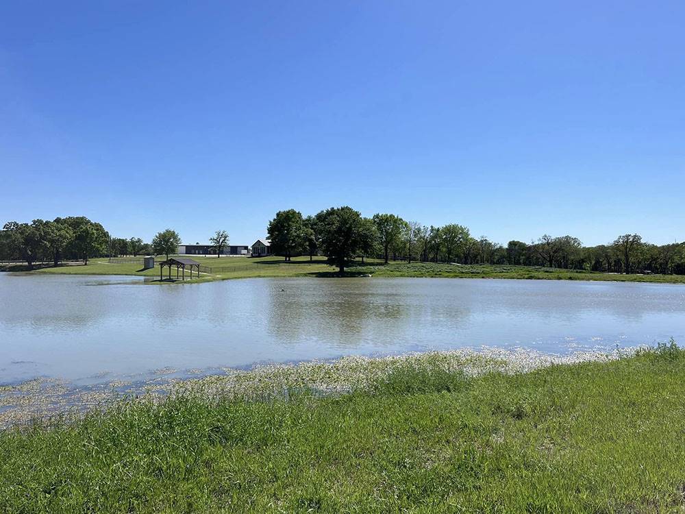 A covered boat ramp by the pond at The Woods RV and Cabin Resort