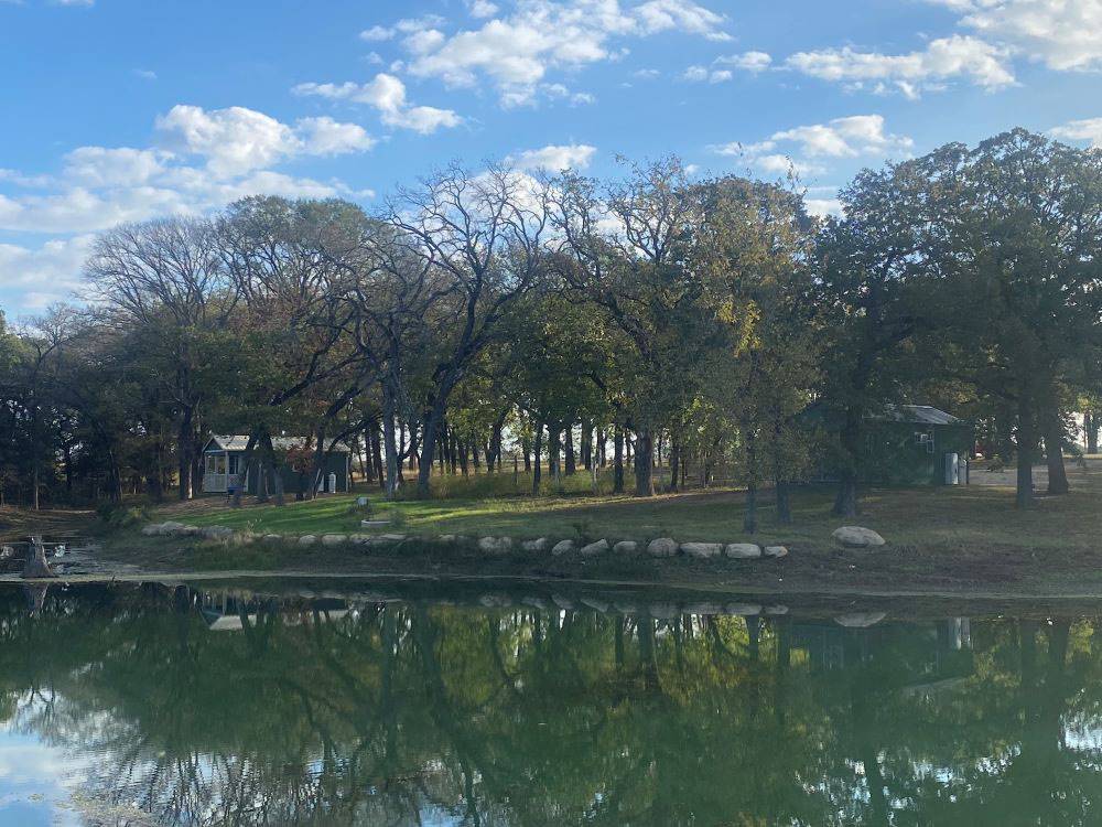 Rental cabins by the pond at The Woods RV and Cabin Resort