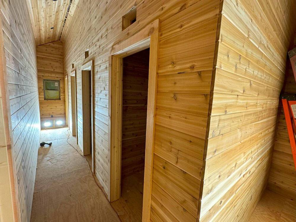 Interior of cabin hallway with rooms on the side at Ptimaster RV Park