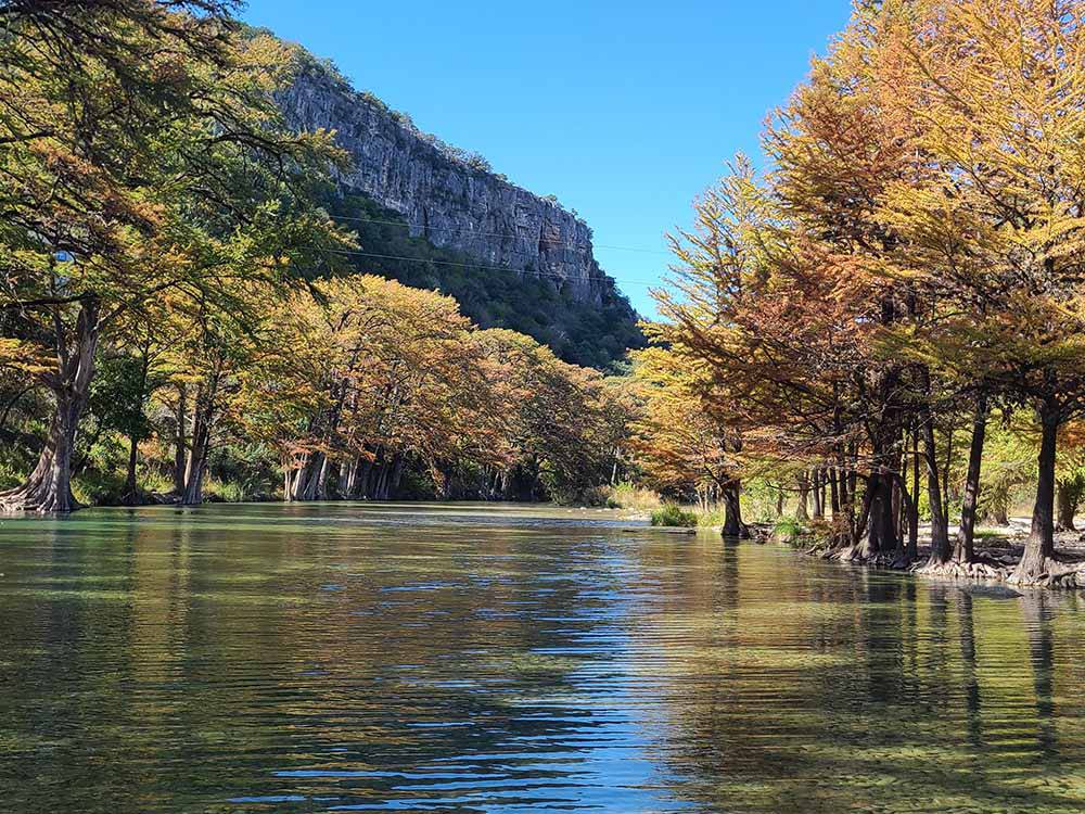 View of the river, trees and mountain at Pitmaster RV Park