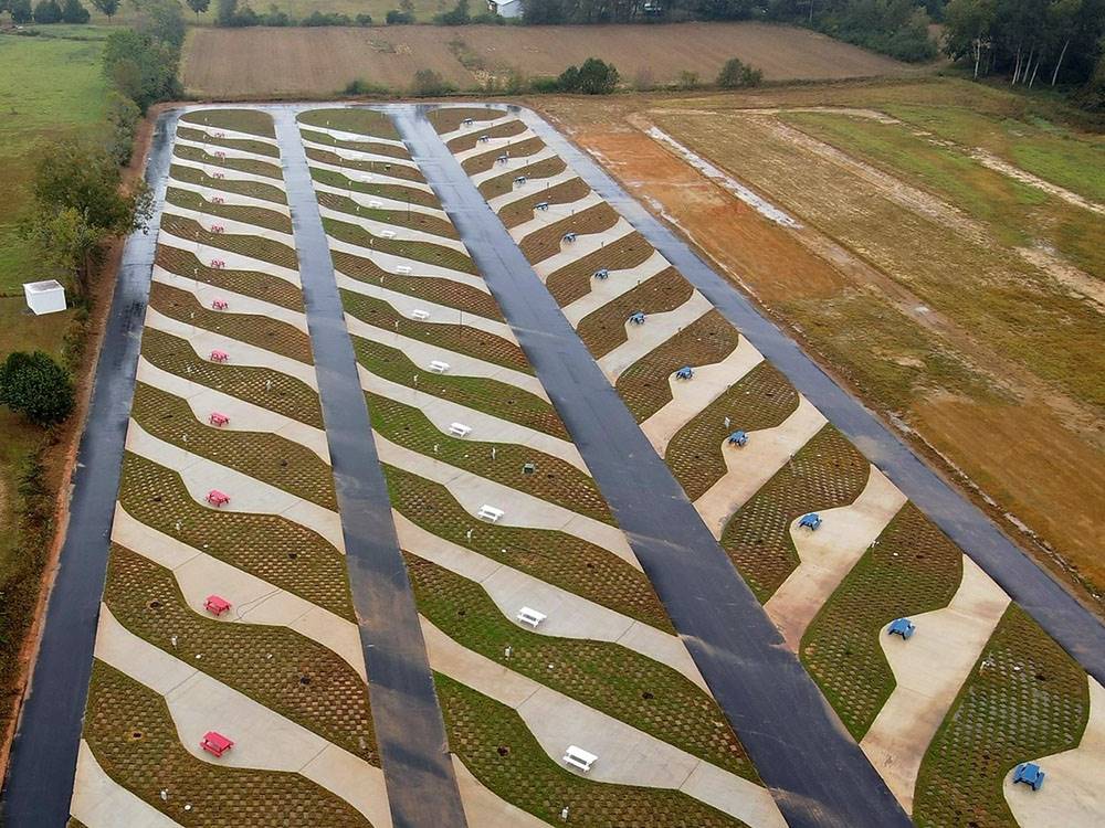 Aerial view of pull thru concrete sites with paved roads at Summer Breeze RV Park