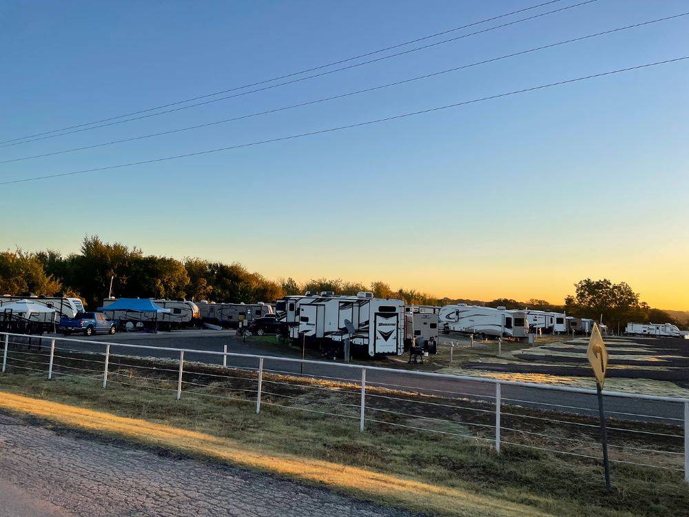 RVs parked in sites at sunset at Waterfront Hideaway Ranch