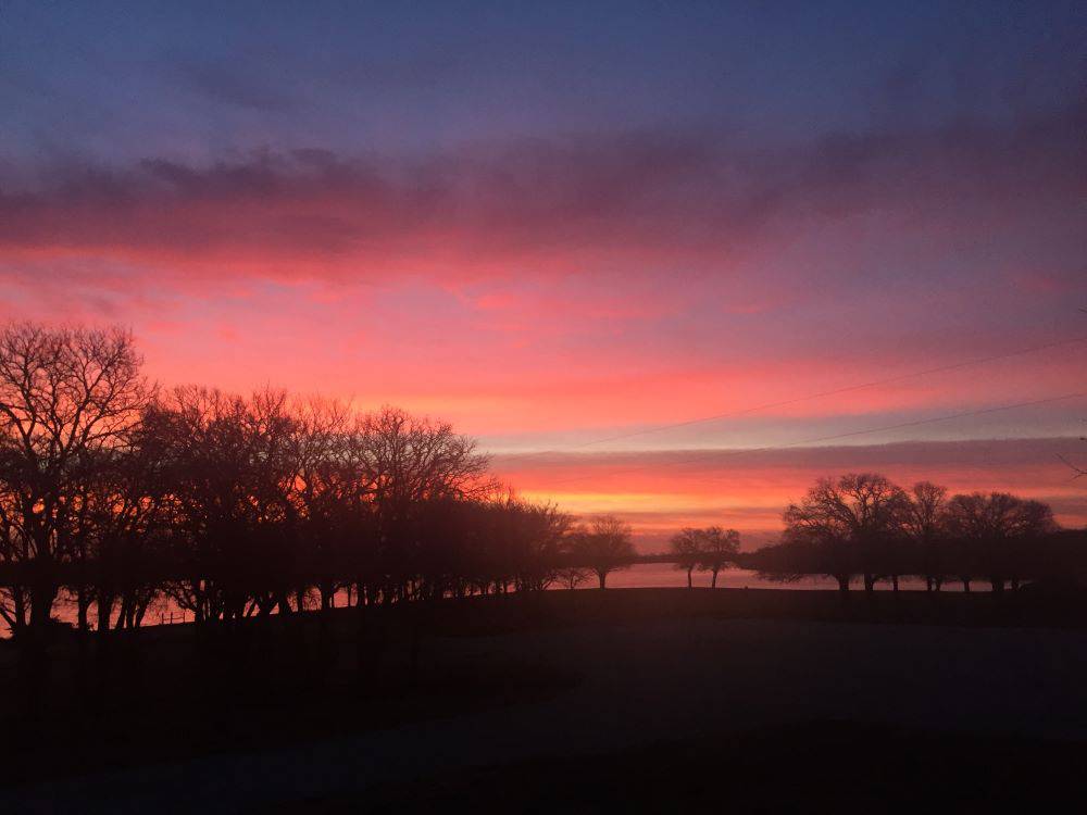 Red and purple sunset sky at Waterfront Hideaway Ranch