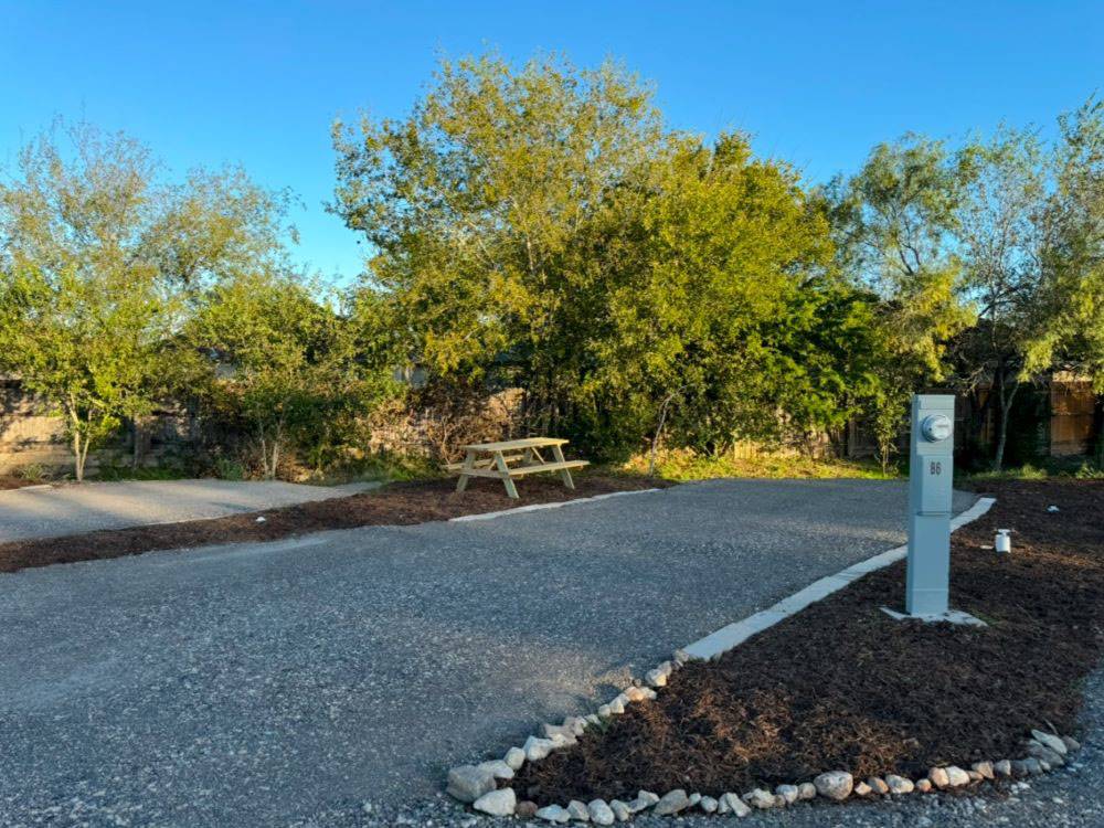 A shaded gravel site and picnic table