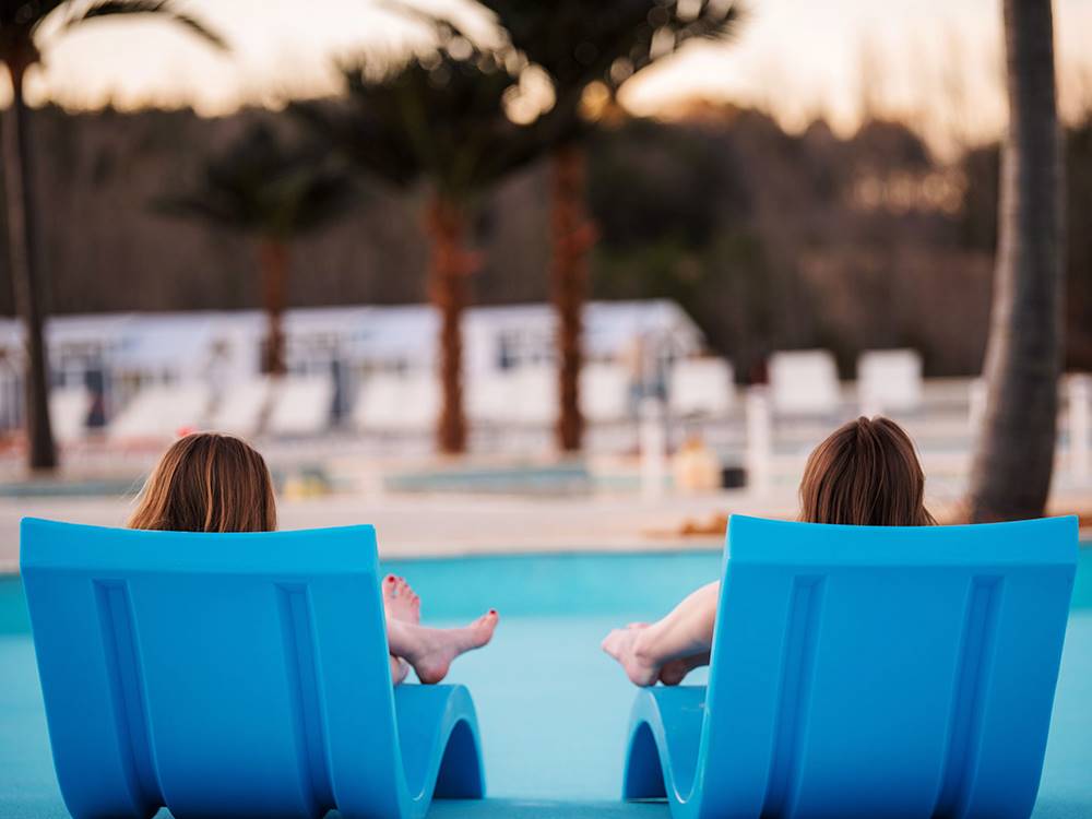 People relaxing by the pool