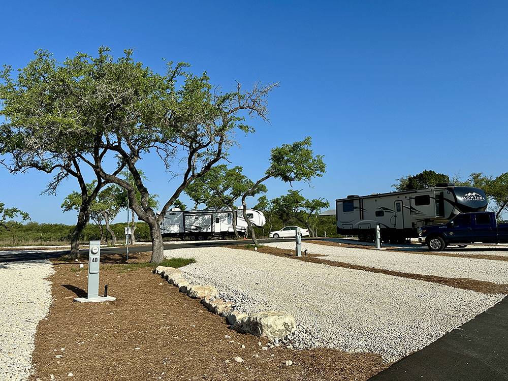 A gravel RV site with hookups