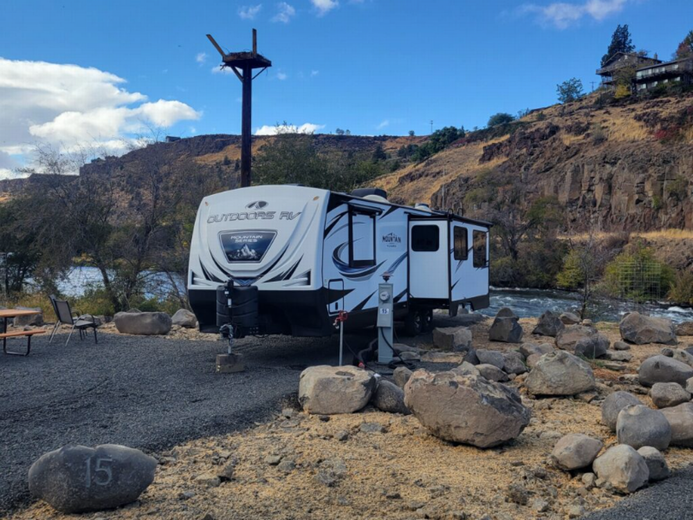 Travel trailer at a river view site at Imperial River Co