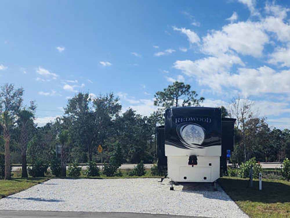 A travel trailer parked in a back-in site