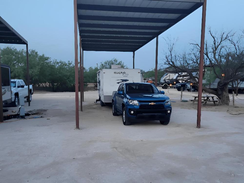 Pickup truck with trailer at site Crossroads RV Park - Big Spring
